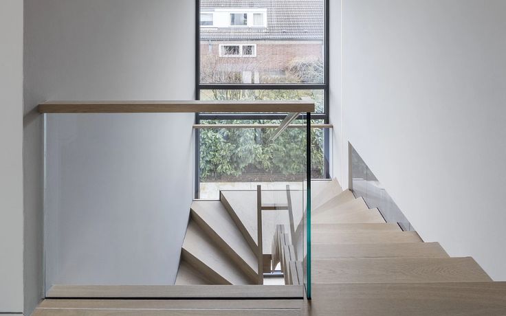 the stairs are made of glass and wood