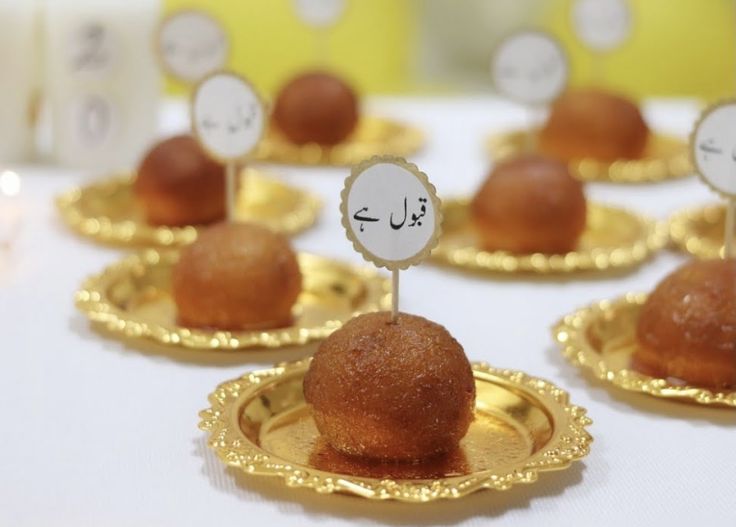 small desserts on gold plates with arabic writing