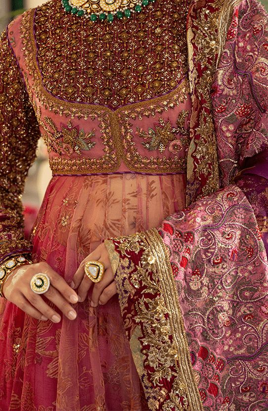 Pakistani Bridal Dress in Pishwas Frock Sharara Style is an iconic attire that has the perfect balance of traditional and glamorous look. Hand-crafted embellishments and luxury designs make this beautiful Pishwas Dress an epitome of beauty and your foremost priority. Pakistani Bridal Pishwas: Pakistani Bridal Pishwas Frock in an alluring pink shade is adorned with hand-crafted details of shimmering sequins, and motifs. Lavish floral designs and fine details of embroidery make this Pakistani Pish Pakistani Suits Bridal, Pink Bridal Pakistani, Bridal Barat Dresses Pakistani, Ghera Embroidery Designs, Pishwas Designs, Heavy Anarkali Dress, Floral Indian Dress, Pakistani Wedding Guest Outfits, Frock Sharara