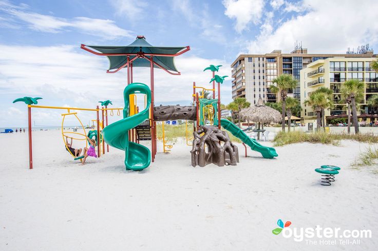 children's play area on the beach with palm trees