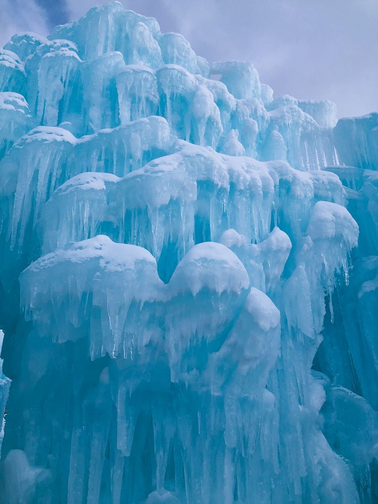 an ice covered mountain with lots of icicles on it