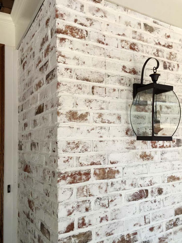 a brick wall with a lantern hanging on it