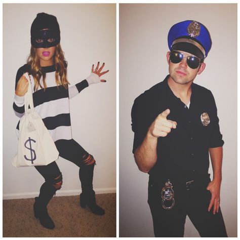 two people dressed up as police officers and one is pointing at the camera with her hand