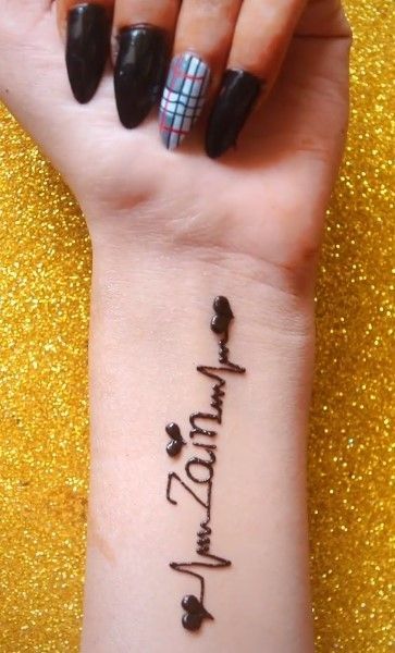 a woman's wrist tattoo with the words happy new year written in cursive writing