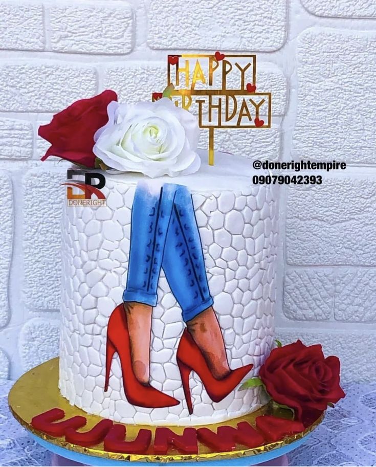 a birthday cake decorated with red high heels and roses