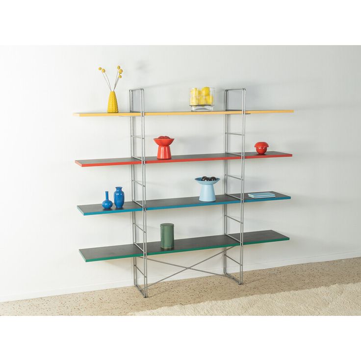 three shelves with vases and other items on them