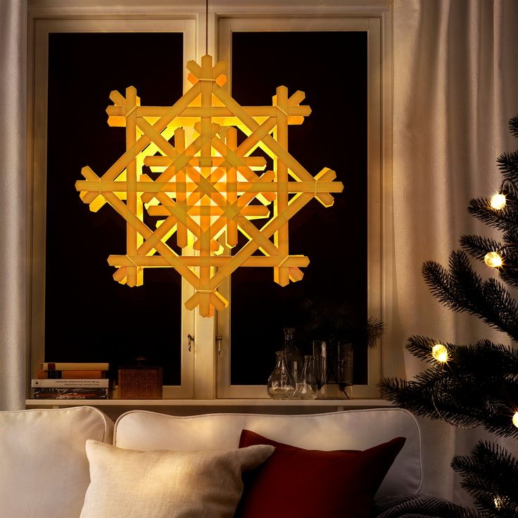 a living room filled with furniture and a christmas tree in front of a large window