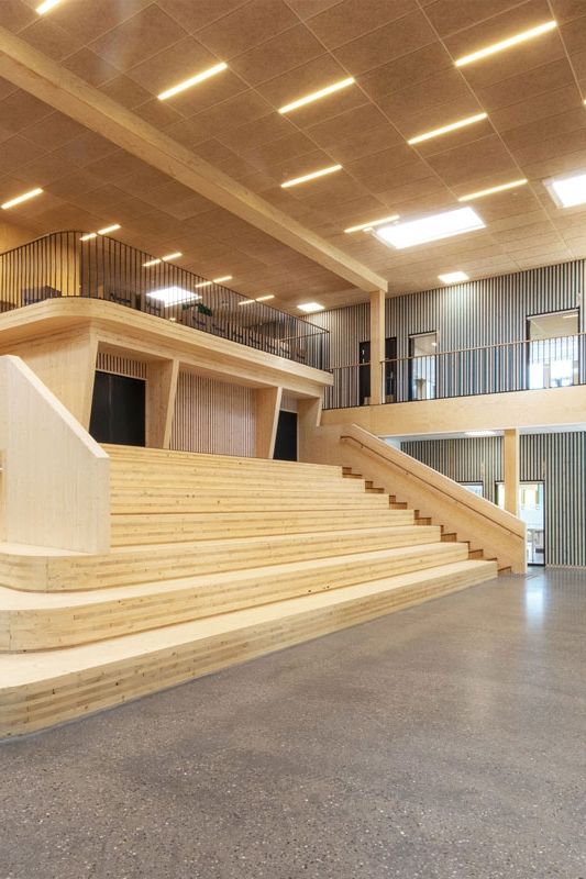 an empty building with wooden stairs and railings