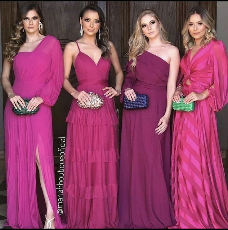 three women in pink dresses standing next to each other with one woman holding a purse