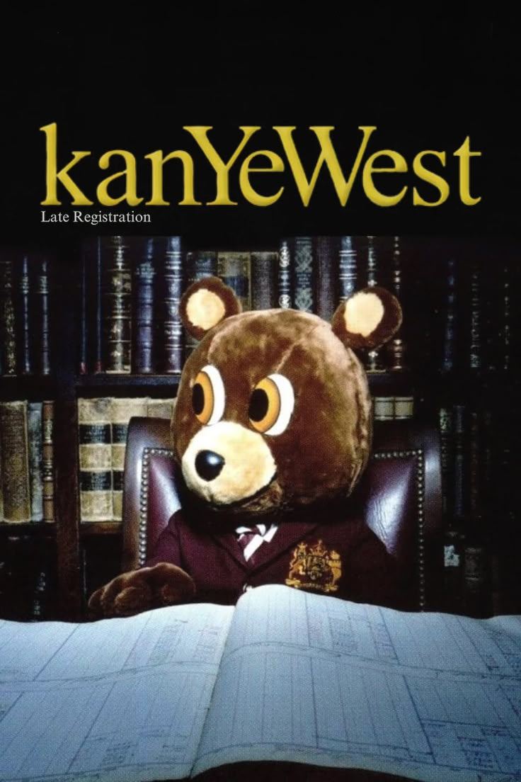 a teddy bear sitting at a desk in front of a book