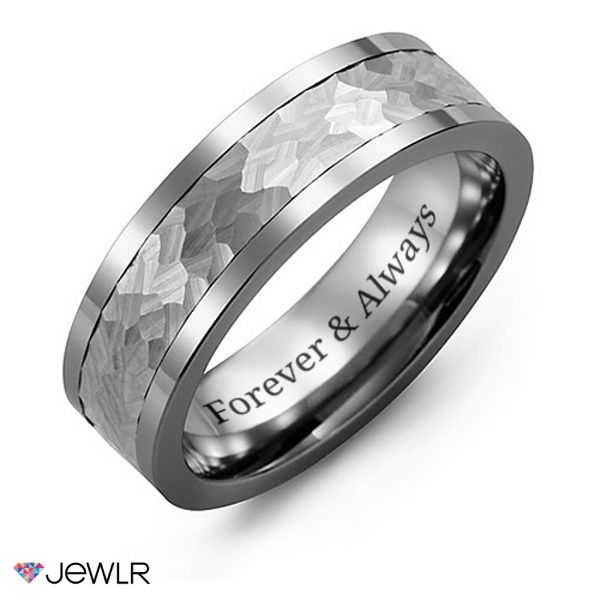 a wedding ring with an engraved message on the center and two rows of white gold inlays