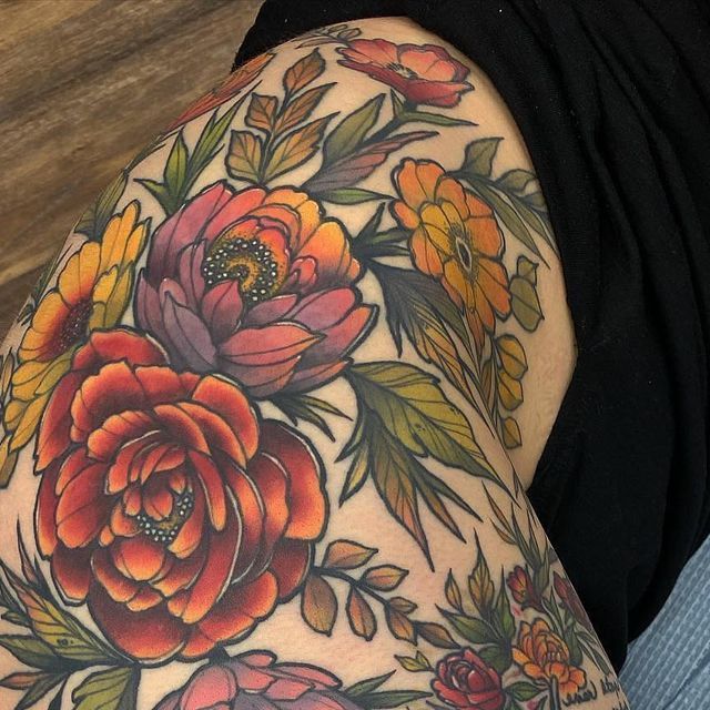 a woman's arm with flowers and leaves painted on the back of her body