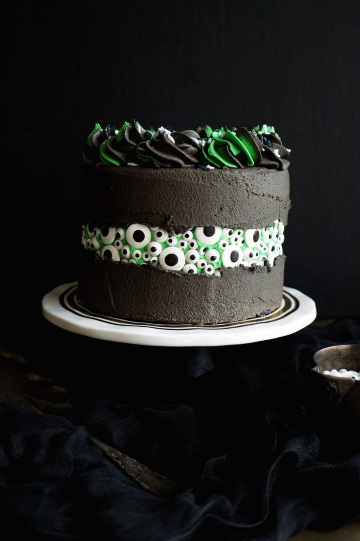 a chocolate cake with green frosting and sprinkles