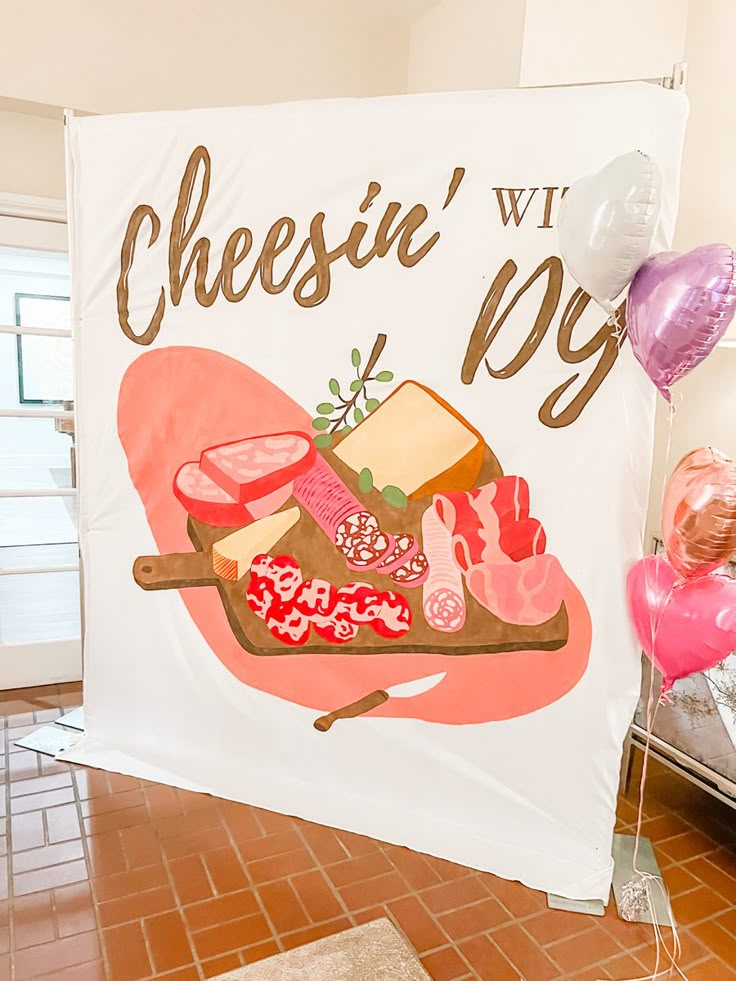 there is a sign that says cheese with joy on it and balloons in the background