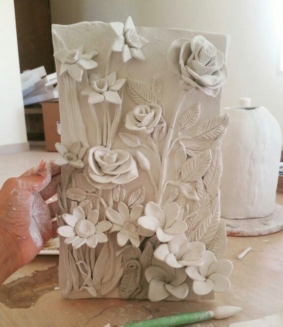 a person is working on a sculpture with flowers