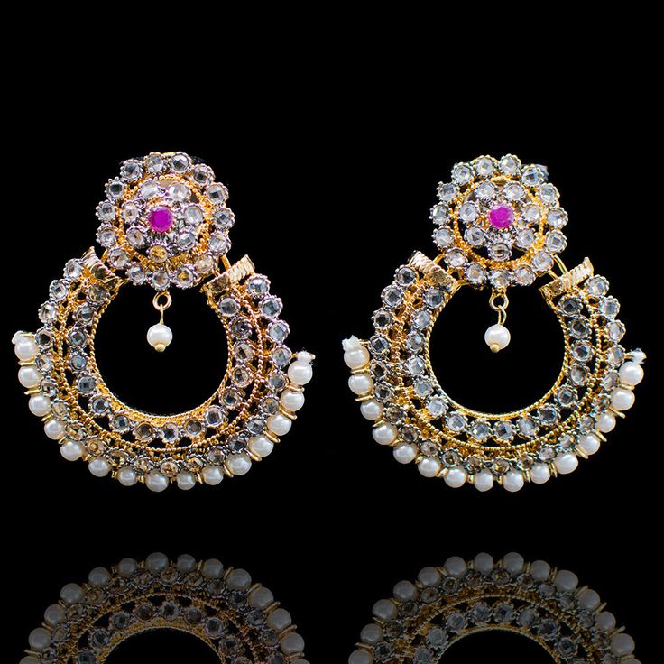 A fun twist! Beautiful earrings with CZ and ruby stones and pearl beads adornments. Approximate earrings length is 1.5". Designed over a high-quality brass as the base metal with gold and rhodium polish. Made by order. Kindly allow 5-7 weeks for the delivery of this item. For custom or urgent requests, please contact support@alacouture.com. *Please Note: We use faux stones and beads in all of our jewelry. Festive Metal Pearl Earrings For Pierced Ears, Gold Plated Bollywood Pearl Drop Earrings, Gold Jeweled Chandbali Pearl Earrings, White Earrings With Stone Work For Gift, White Stone Work Earrings For Gift, Jeweled Round Metal Earrings, Bollywood Style Silver Gold Plated Earrings, Hand Set Pearl Chandbali Earrings, Silver Jeweled Chandbali Earrings