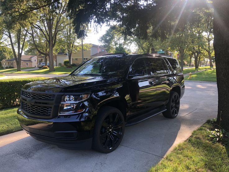 a black suv parked on the side of a road