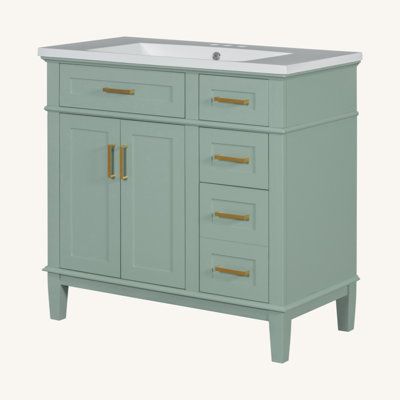 an image of a bathroom vanity with gold handles and drawers on the bottom drawer in pastel green