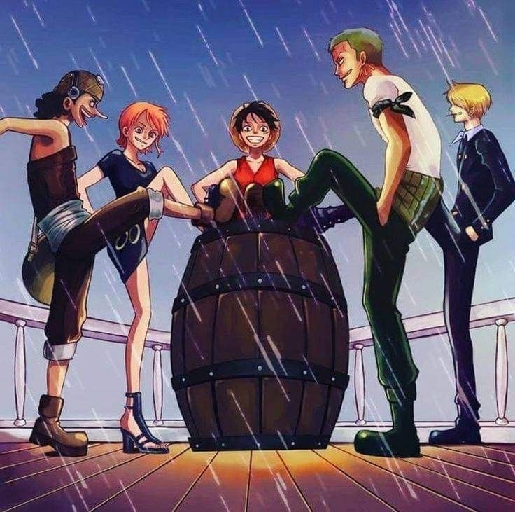 four people standing around a wooden barrel in the rain