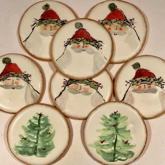 six decorated cookies with santa claus on them