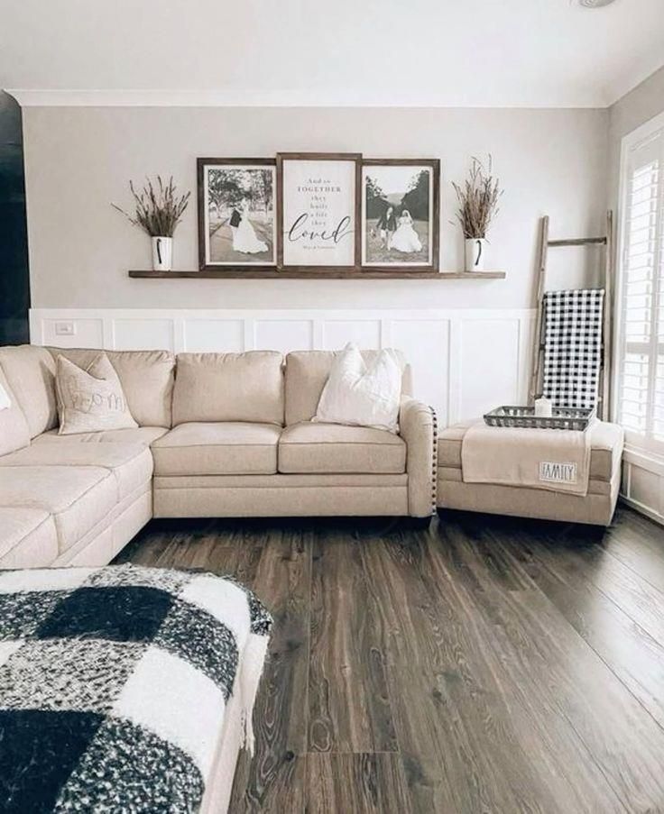 a living room filled with furniture and pictures on the wall above it's windows