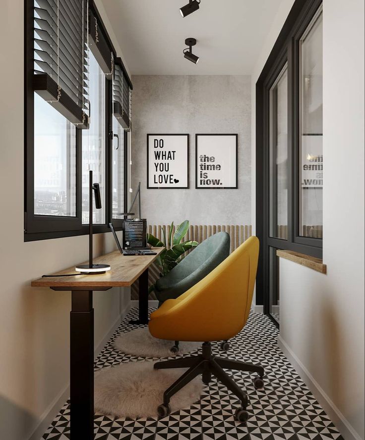 a yellow chair sitting in front of a window next to a desk