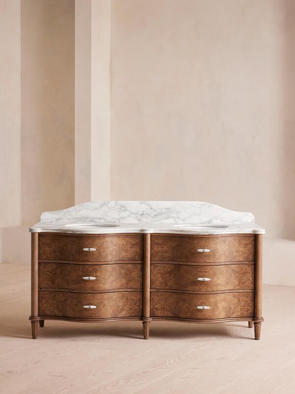 a marble topped wooden dresser in an empty room with beige walls and flooring on the side