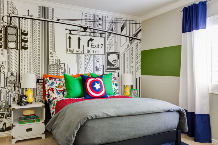 a bedroom decorated in green, white and blue with a captain america mural on the wall