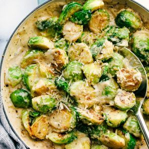 a pan filled with brussel sprouts and cheese