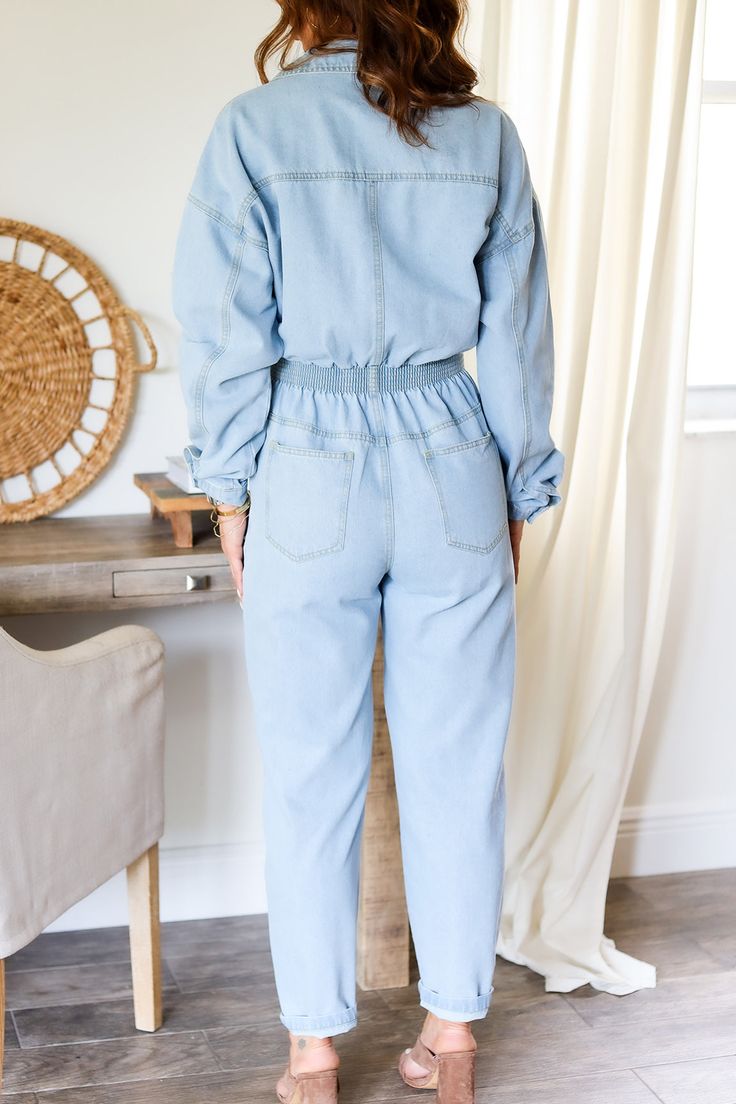 The jumpsuits of all jumpsuits - reprising it's role of our favorite denim jumpsuit - we have restocked this dream denim jumpsuit. Button down denim jumpsuit with button and zipper closure. 100% Cotton Color: Lt. Denim Button Down Jumpsuit Long sleeve Functional pockets Button/Zipper Closure 1/2 elastic waist band (back) Cuffed ankle Collard style Western Belt Detail True to size Model is wearing a size Small. She is 5'6". 130lbs. Bust: 34" Waist 26" Hips 36" Utility Denim Button-up Jumpsuits And Rompers, Denim Utility Jumpsuit With Button-up Design, Light Wash Button-up Denim Jumpsuit, Light Wash Button-up Jumpsuits And Rompers, Light Wash Button-up Jumpsuit Or Romper, Light Wash Denim Button-up Jumpsuits And Rompers, Dark Wash Button-up Jumpsuits And Rompers With Pockets, Denim Button-up Jumpsuits And Rompers With Pockets, Denim Button-up Jumpsuits And Rompers With Relaxed Fit