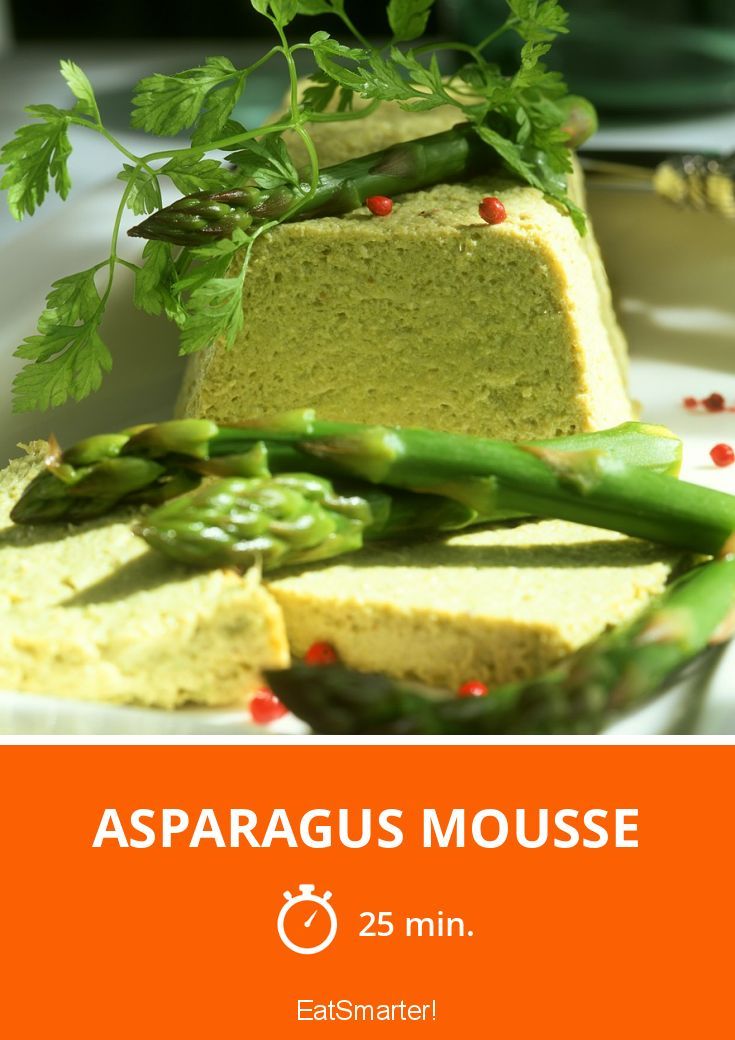 asparagus mousse on a white plate with green garnishes