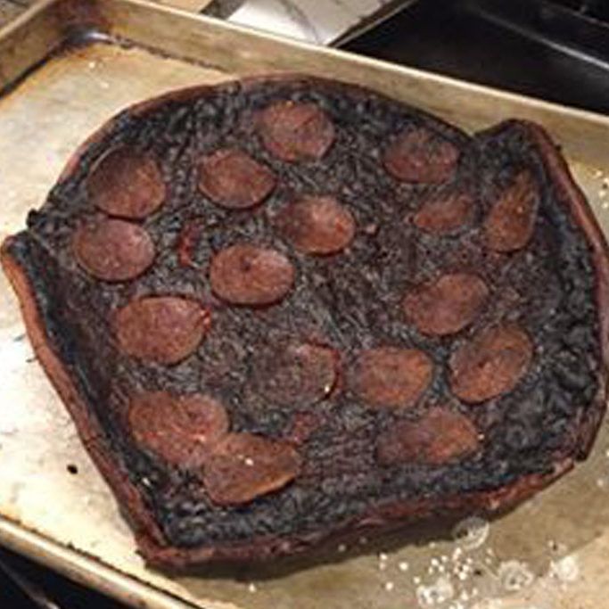 a piece of chocolate cake sitting on top of a metal pan next to an oven