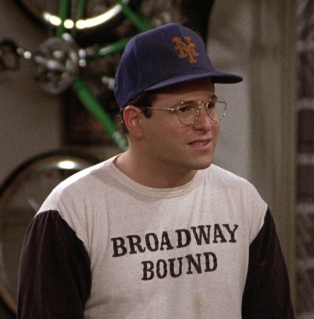 the young man in glasses is wearing a baseball cap and t - shirt that says broadway bound