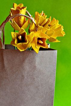 a brown paper bag with yellow flowers in it