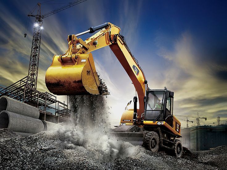 an excavator is dumping gravel onto the ground with it's back end