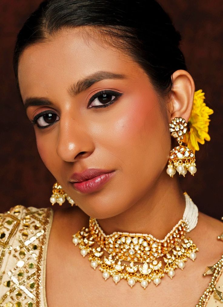 Elevate your festive wardrobe with the exquisite Gold Finish Kundan Choker Set, masterfully crafted from mixed metal and adorned with radiant Kundan and Pearl stones. The choker, beautifully strung with delicate pearl lines, exudes a regal charm, while the matching jhumka earrings add a touch of traditional elegance. Finished with a rich 22kt gold plating, this set is perfect for weddings, parties, and other Indian festivities, offering a harmonious blend of timeless tradition and modern sophist Festive Tilla Chandbali Pearl Necklace, Festive Chandbali Pearl Necklace With Intricate Design, Festive Chandbali Pearl Necklace For Celebration, Heavy Pearl Necklace For Festive Occasions, Bollywood Style Pearl Necklace For Diwali Ceremonies, Festive Pearl Necklace With Intricate Design, Elegant Kundan Necklace With Gota Work For Ceremonial Occasions, Intricate Design Kundan Choker Necklace For Celebration, Kundan Choker Necklace With Intricate Design For Celebration