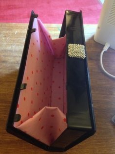 an open wallet sitting on top of a wooden table