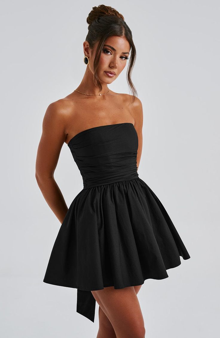 THE dress of the season has landed and you're going to be obsessed. Meet Katrina, our dreamy mini with a pretty, voluminous skirt and waist cinching bodice. Fastening with a zip to the back, tie with an oversized bow to complete the look for perfect feminine drama. 



Colour: Black.

Premium non-stretch cotton blend fabric.

Fully lined.

Strapless ruched bodice with boning.

Waist cinching.

Oversized tie to create bow detail to back.

Voluminous skirt with tulle lining.

Zip fastening to the Voluminous Skirt, Split Long Dress, Loungewear Dresses, Maxi Dress Sale, Maxi Dress Navy, Ruched Bodice, Jumpsuit Shorts Rompers, Formal Party, Dress Pant