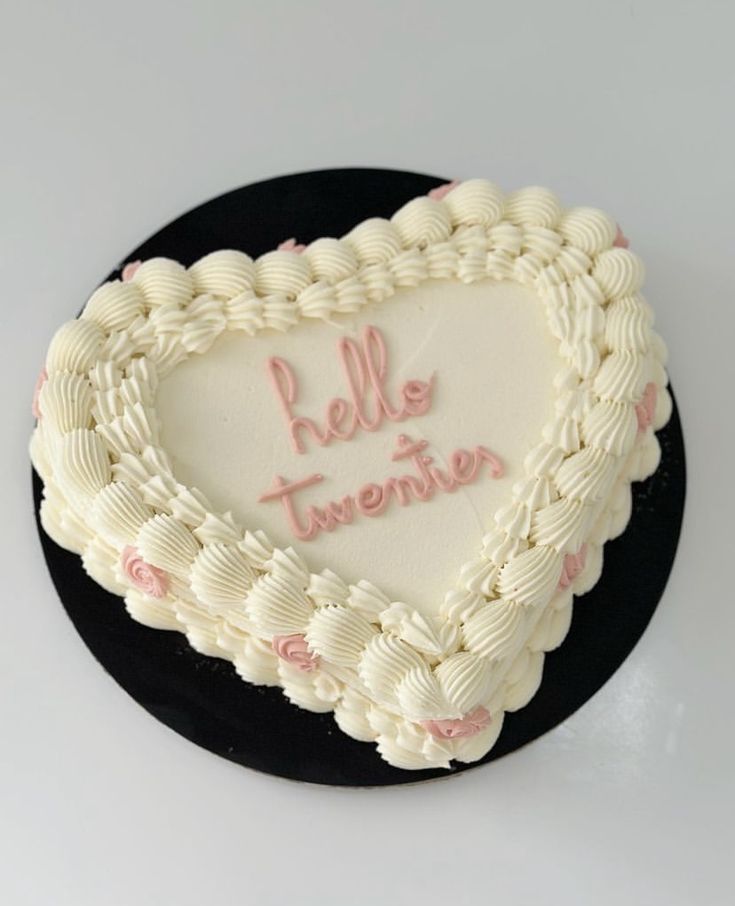 a heart shaped cake with writing on it