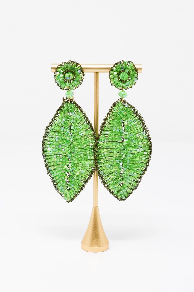 The Lavish by TM Green Leaf Earrings are beautiful addition to any outfit! Material: Enameled wire, hypoallergenic and nickel-freeOrigin: Hand made in Brazil Stud closure Hand crocheted Lightweight 3.5" drop Lavish by Tricia Milaneze is ethereal and lace designs are ideal for women looking for an attractive accessory, but avoiding solid, heavy jewelry. All pieces are extremely feminine, wearable and accessible. Elegant Green Hypoallergenic Beaded Earrings, Green Metal Beaded Earrings For Party, Green Leaf-shaped Party Jewelry, Green Metal Beaded Party Earrings, Luxury Ornate Green Earrings, Bohemian Green Leaf-shaped Jewelry, Green Teardrop Nickel-free Chandelier Earrings, Green Leaf-shaped Earrings, Hypoallergenic Green Flower-shaped Earrings