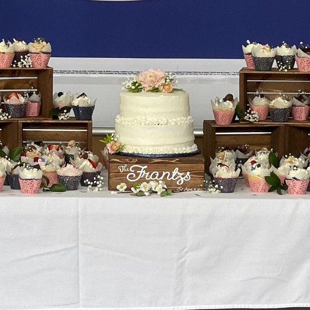 a table topped with lots of cakes and cupcakes