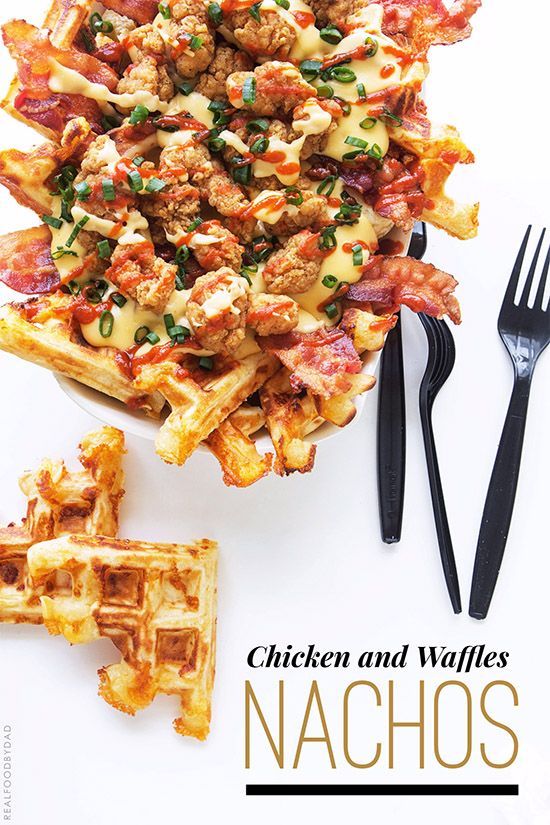 chicken and waffles nachos on a white plate with black utensils