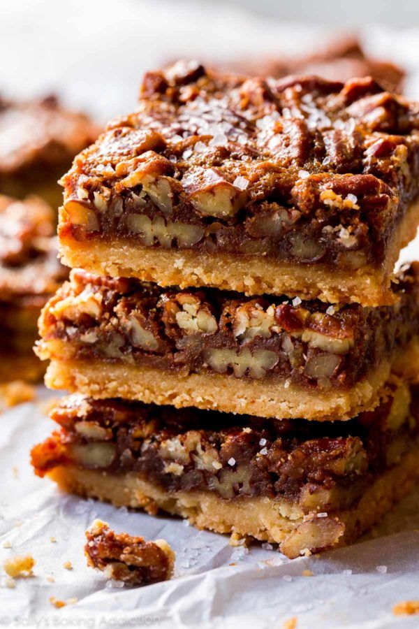 three pieces of chocolate pecan bars stacked on top of each other