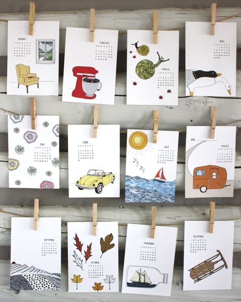 calendars are hung on clothes pins with magnets attached to them