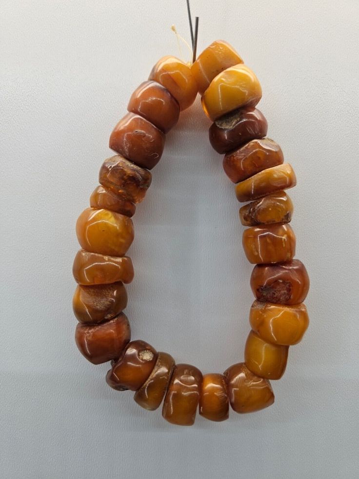 Antique Amber Jewelry With Large Beads, Vintage Amber Polished Beads, Gems, And Cabochons, Vintage Amber Gemstone Beads, Antique Amber Round Bead Jewelry, Traditional Amber Round Beads And Cabochons, Antique Amber Beads For Jewelry Making, Vintage Amber Oval Beads Jewelry, Vintage Amber Oval Beaded Jewelry, Vintage Amber Jewelry With Oval Beads