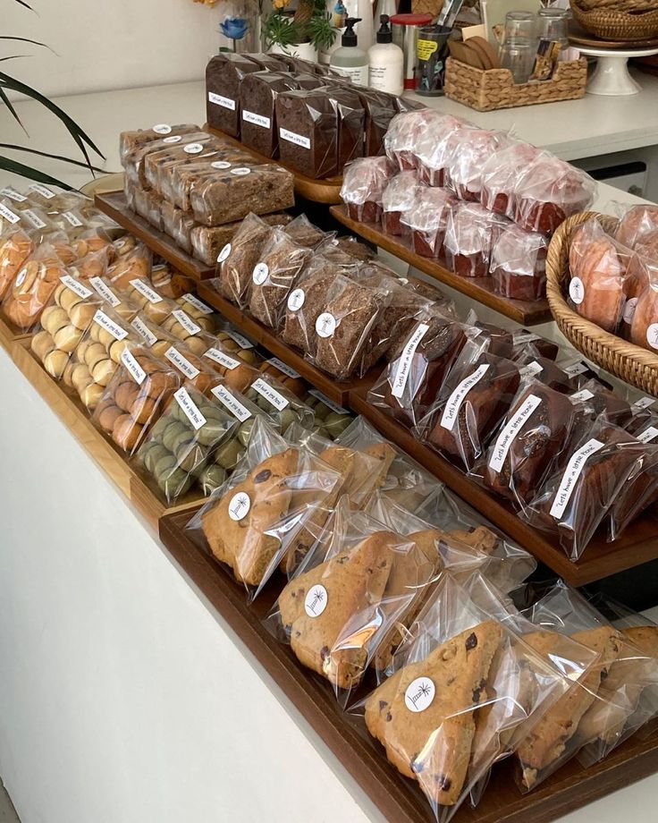 there are many different types of cookies on the counter in this bakery shop, and one is wrapped with plastic