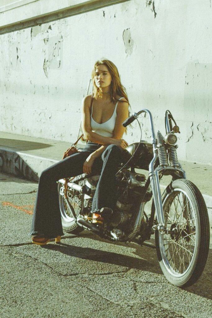 a woman sitting on top of a motorcycle