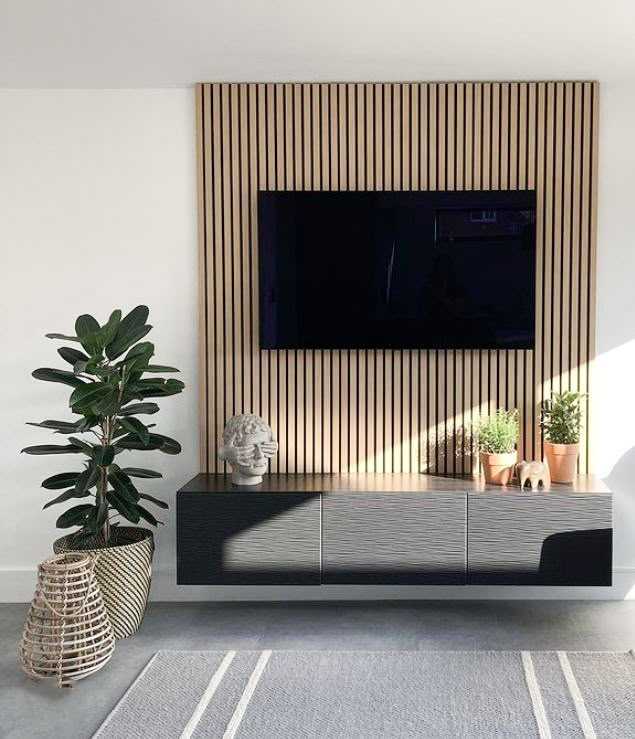 a living room with a large flat screen tv mounted on the side of it's wall