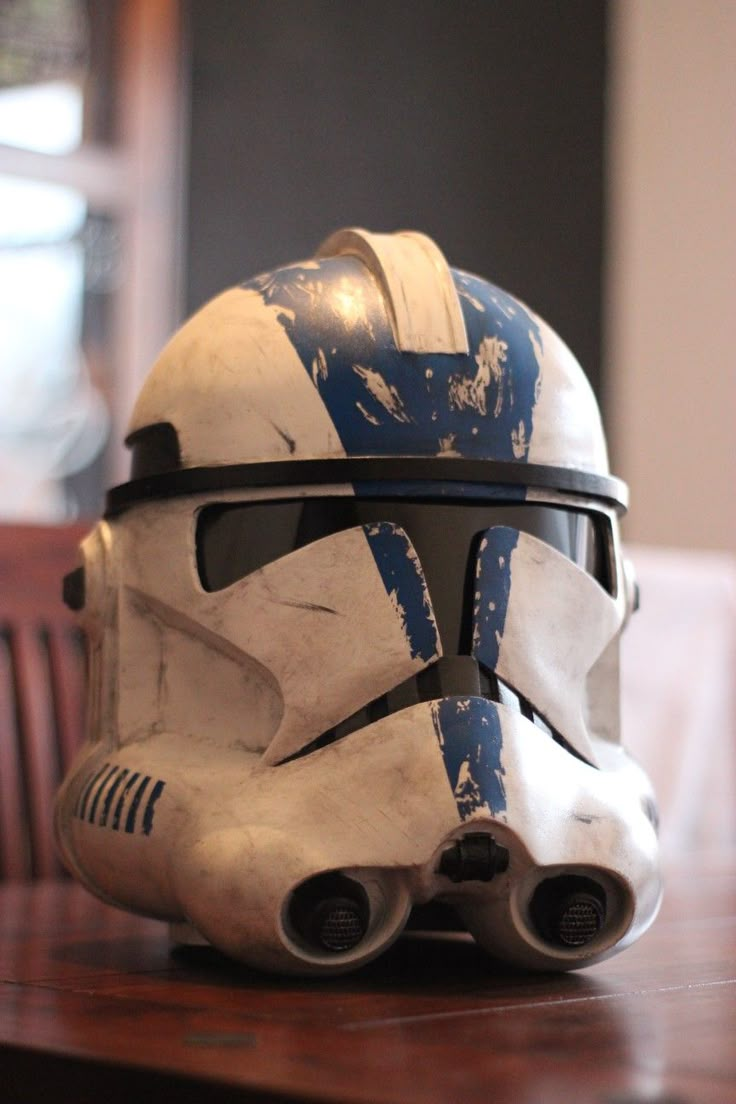 a star wars helmet sitting on top of a wooden table