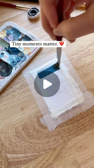 someone is painting something on the table with their thumbnails and using it as a marker